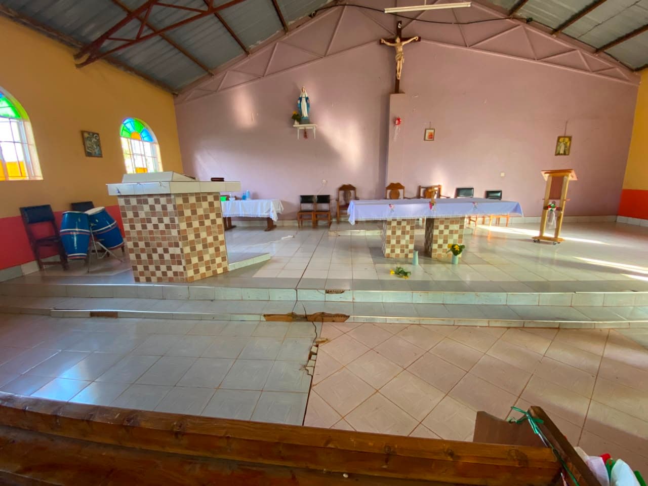 Cracks spreading across the sanctuary floor near the altar.